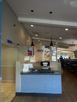 A restaurant dining area with a tablet survey station on the counter.