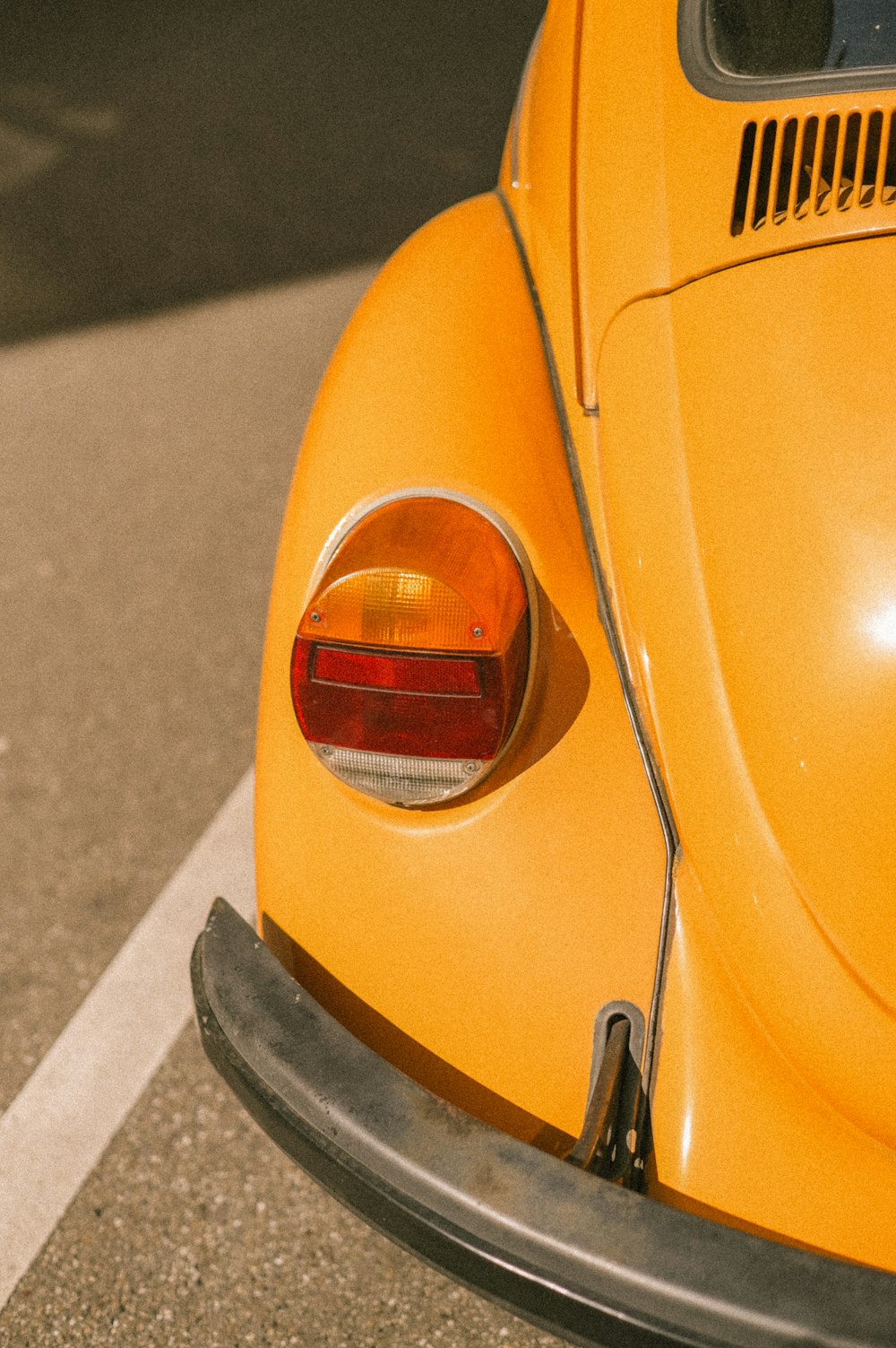 a close up of the tail end of a yellow car