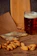 Close-up of a smoked fish platter with a frothy beer glass beside it on a rustic wooden table.