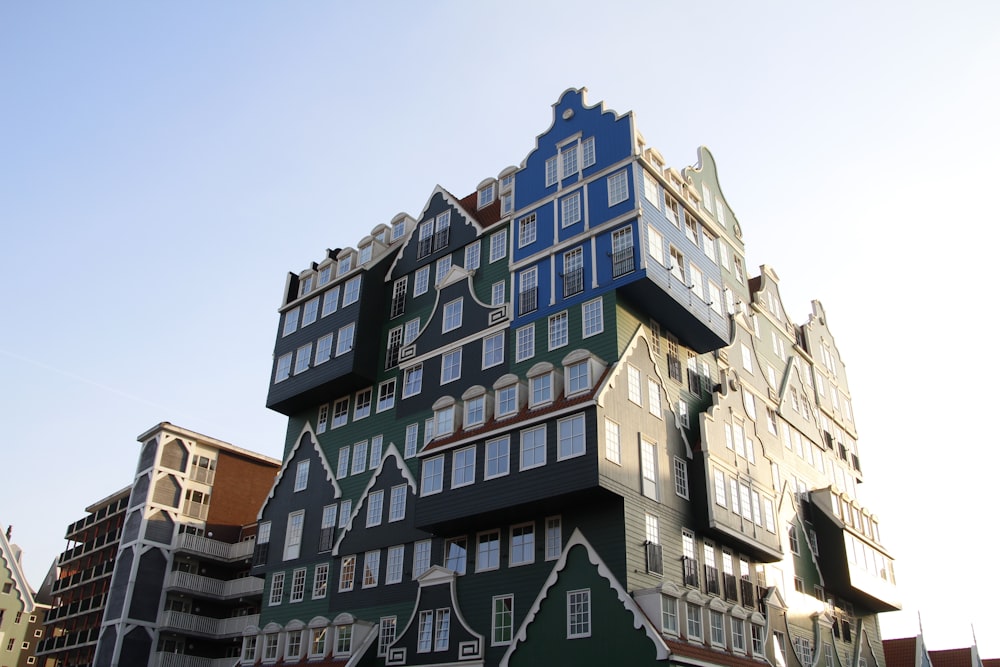 a multi - colored building with many windows and balconies