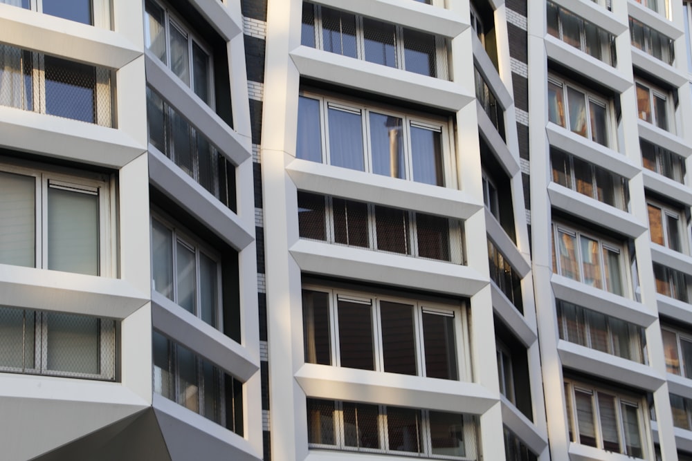 a tall white building with lots of windows