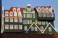 Close-up of a modern dakkapel with blue accents on a traditional Dutch house.