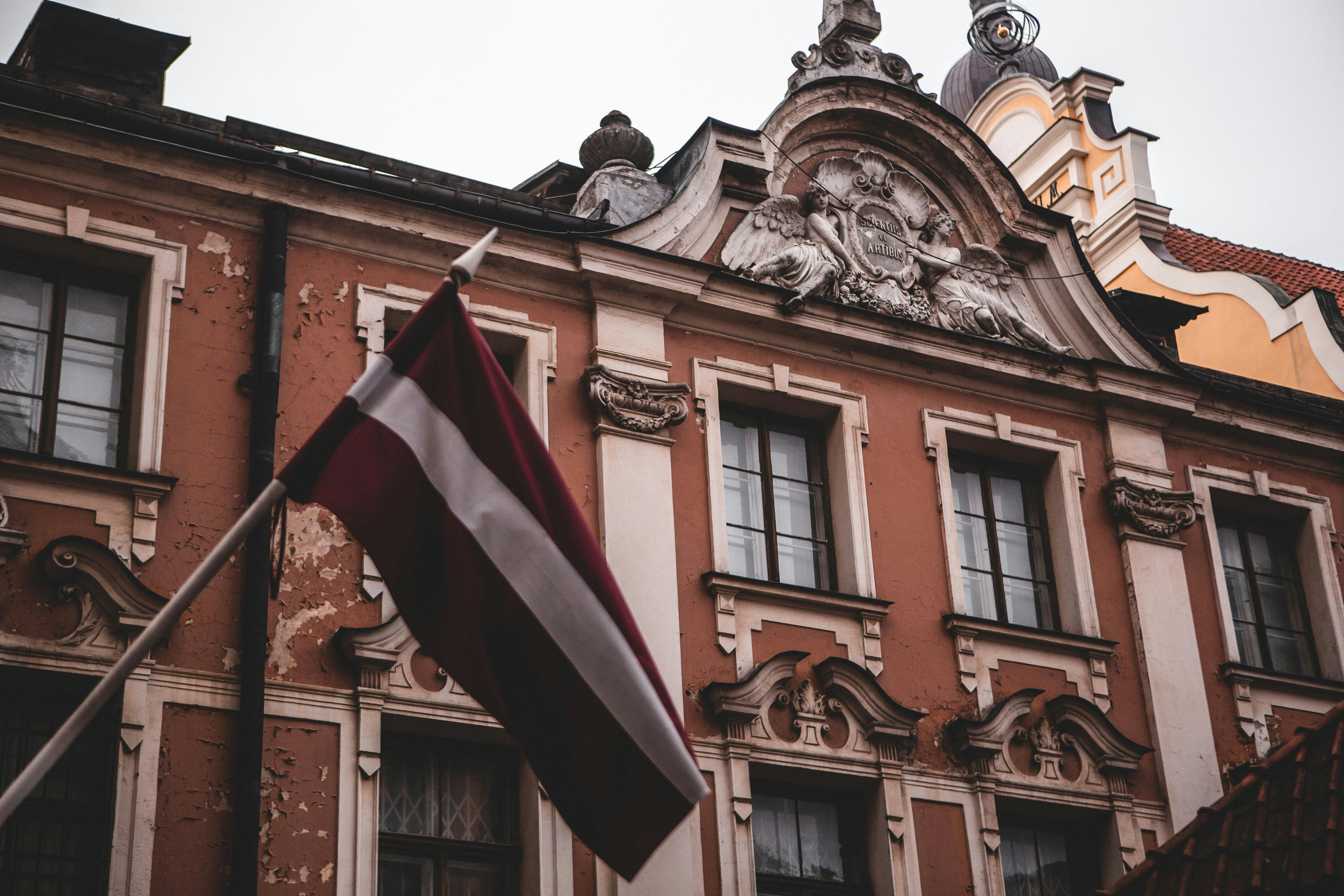 a flag on a pole in front of a building