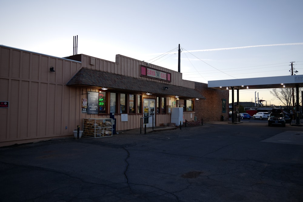 a gas station with a car parked in front of it