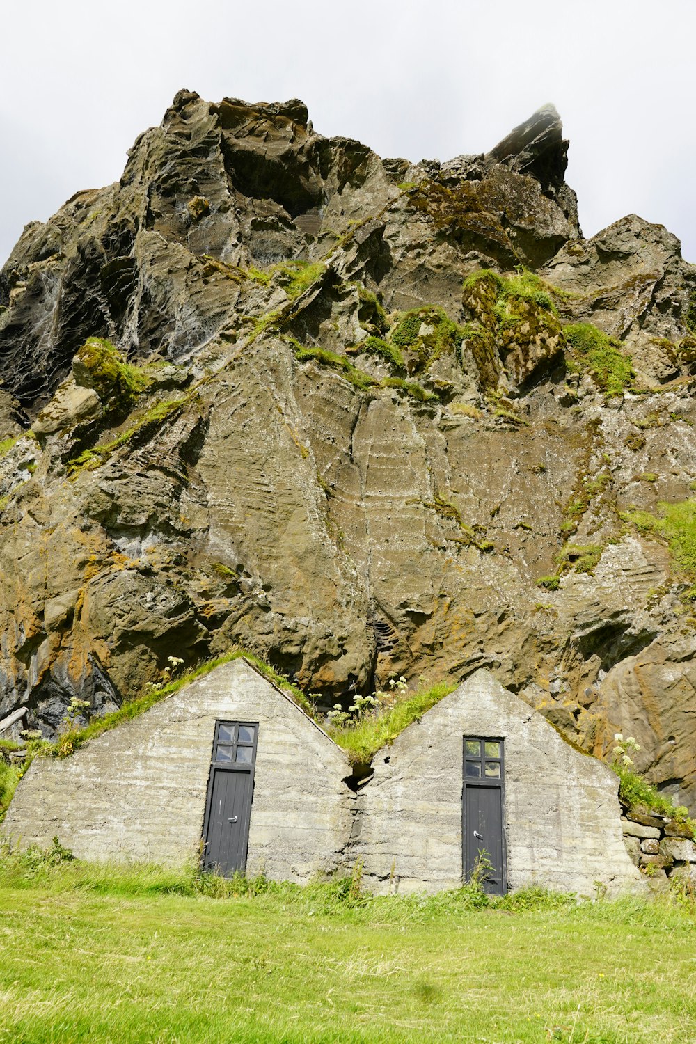 a rock formation with two doors in front of it