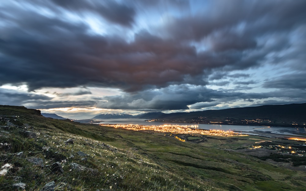 a view of a city from a hill at night