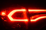 Close-up of vibrant LED lights glowing under a car’s chassis at night.