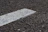 Close-up of geotextile fabric being laid down on a road construction area.