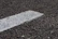 Close-up of geotextile fabric being laid down on a road construction area.