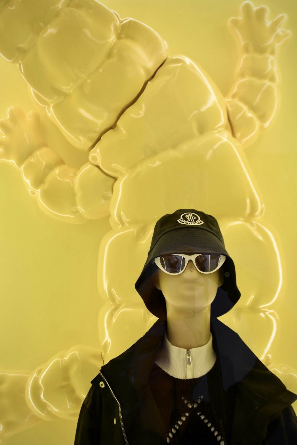 a mannequin wearing a hat and sunglasses