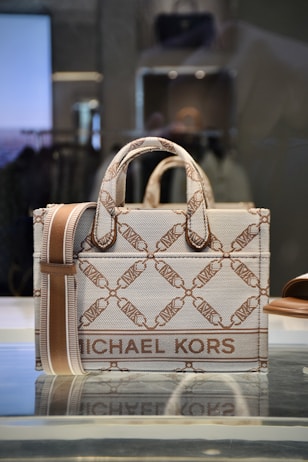 a michael kors bag on display in a store window