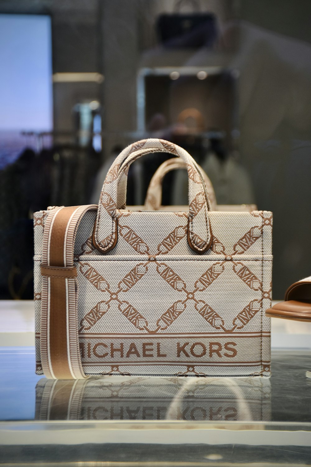 a michael kors bag on display in a store window