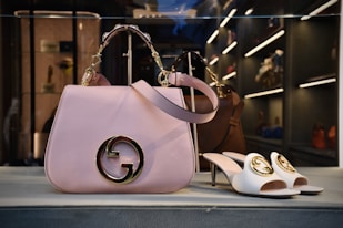 a pair of shoes and a handbag on display