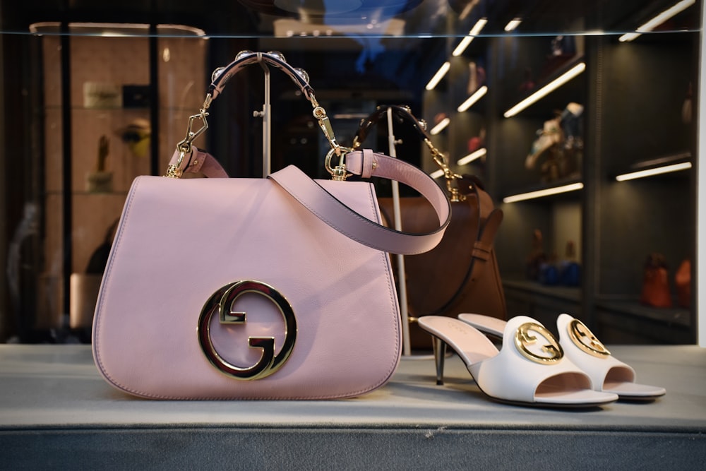 a pair of shoes and a handbag on display