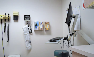 a room with a desk, phone, and other items on the wall