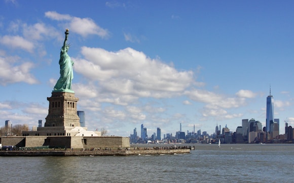 a view of the statue of liberty from across the water