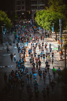 a large group of people running a marathon down a street