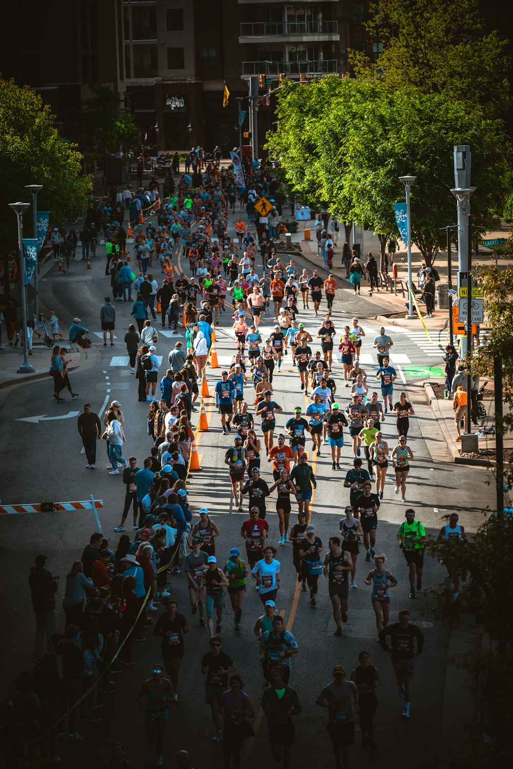 a large group of people running down a street