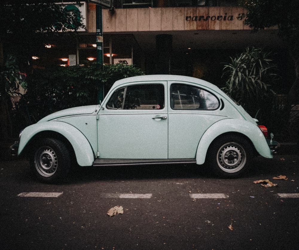 a blue car parked in front of a building