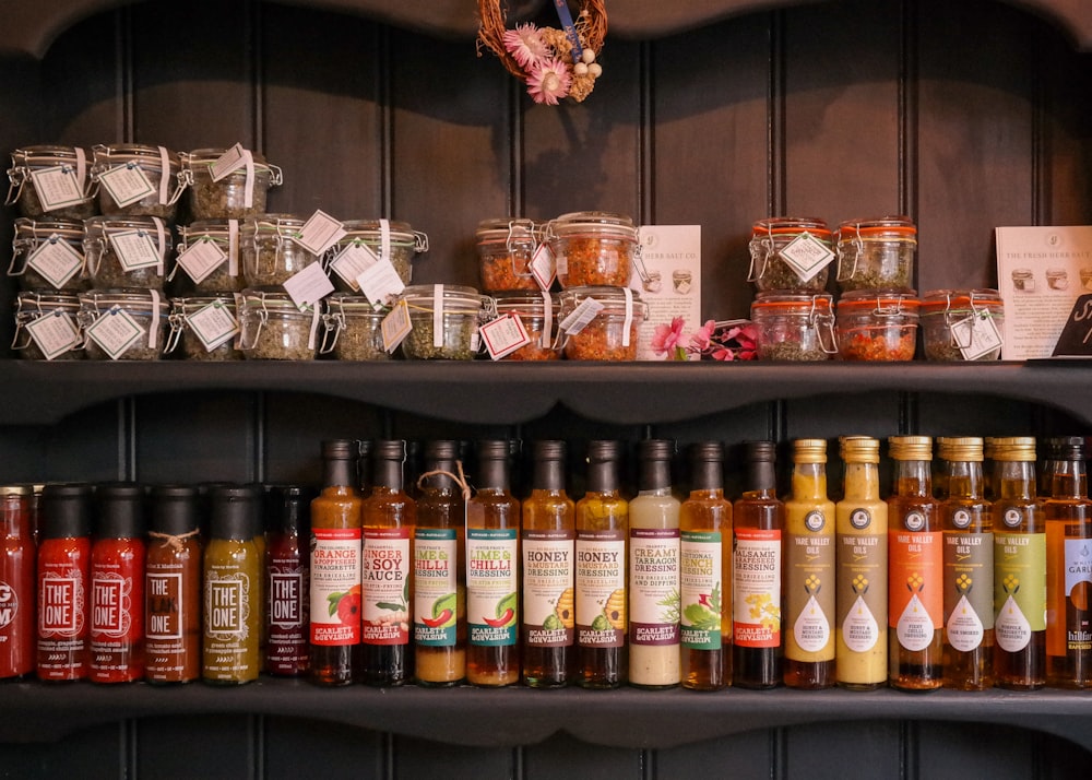 a shelf filled with lots of different types of condiments