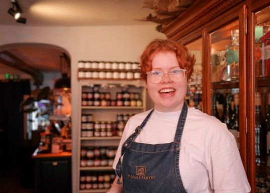 Friendly shopkeeper assisting a smiling customer in a cozy store environment.
