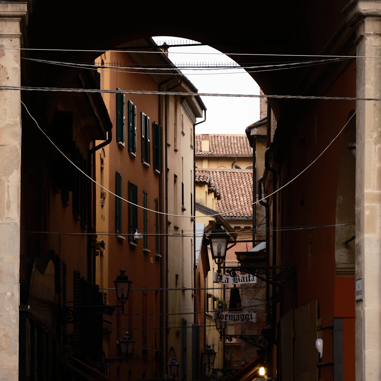 A narrow street lined with old buildings in Bologna's historic centre