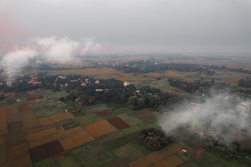 an aerial view of a rural area in the fog