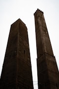 Bologna old city with the two towers Asinelli and Garisenda rising above the terracotta medieval rooftops