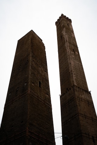 Bologna old city with the two towers Asinelli and Garisenda rising above the terracotta medieval rooftops