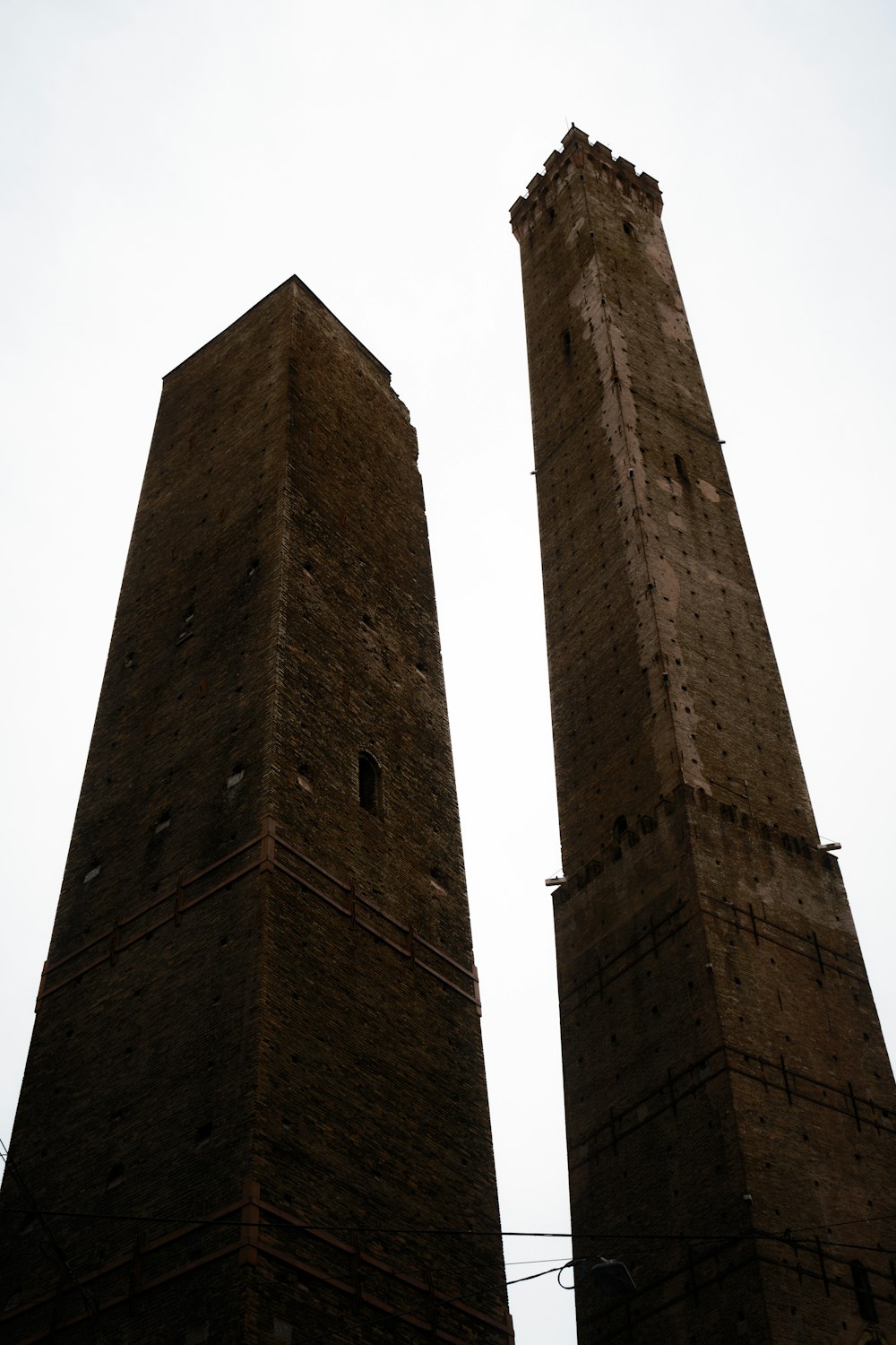 a couple of tall brick towers sitting next to each other