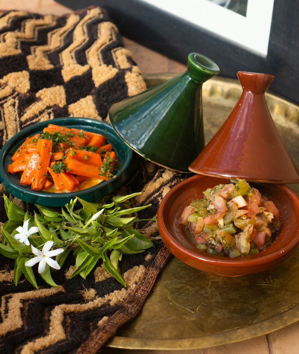 a plate with a bowl of food and a bowl of vegetables