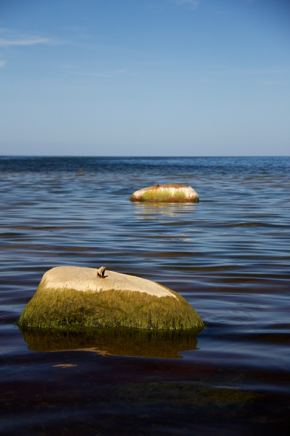 a rock in the middle of a body of water