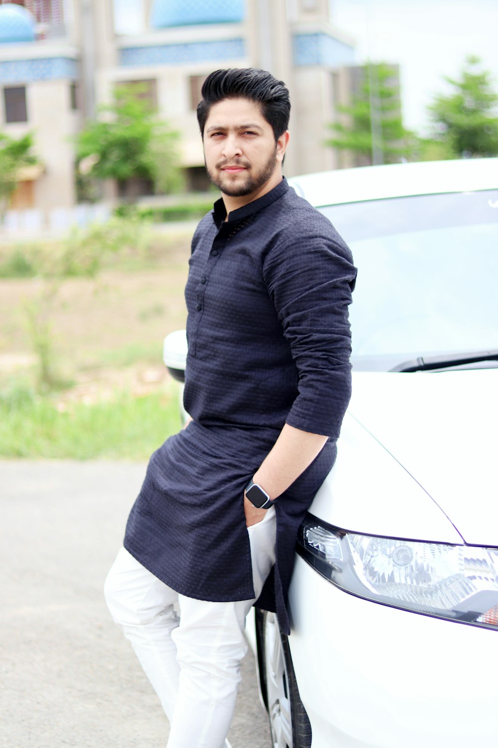 a man standing next to a white car