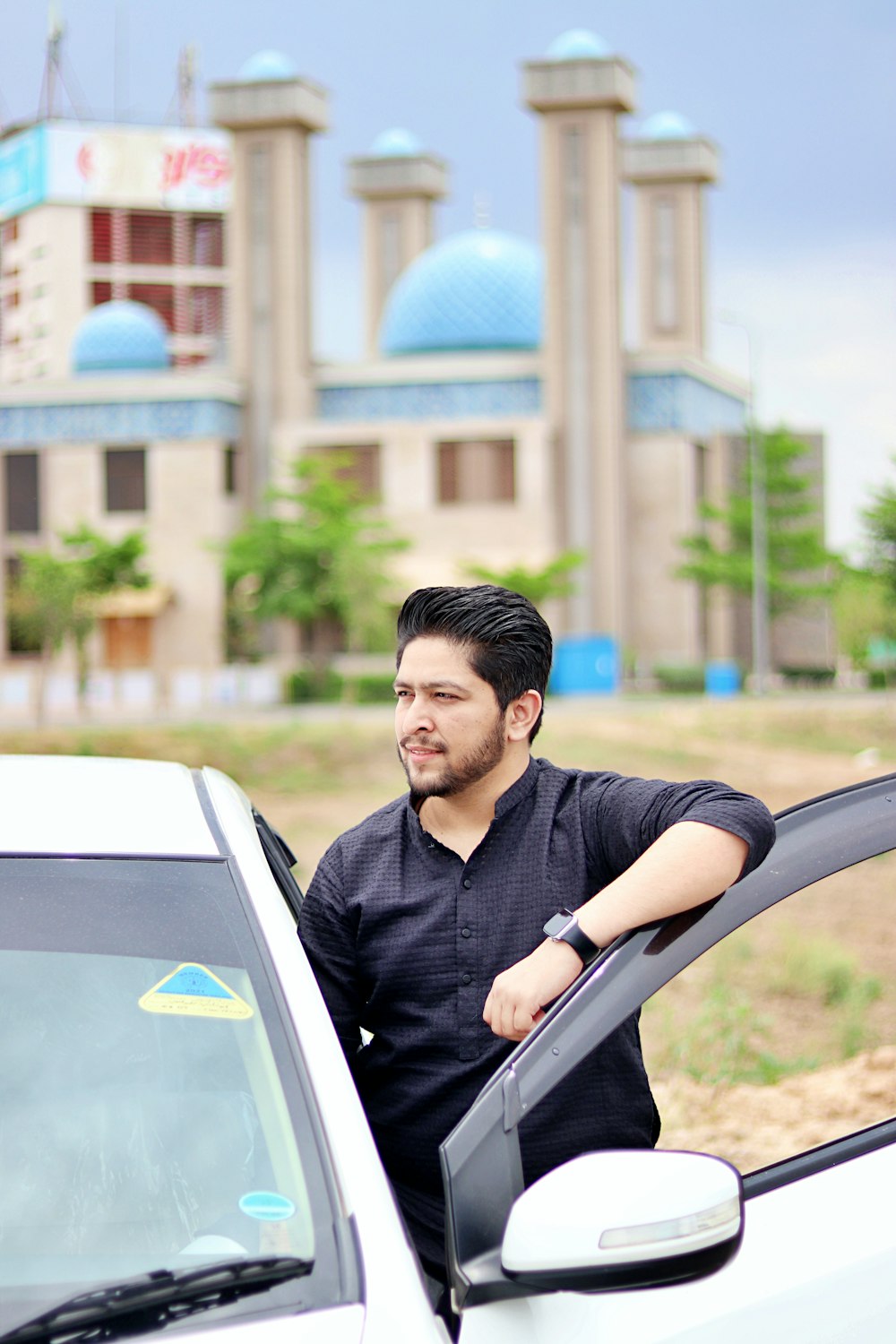 a man sitting in the drivers seat of a car