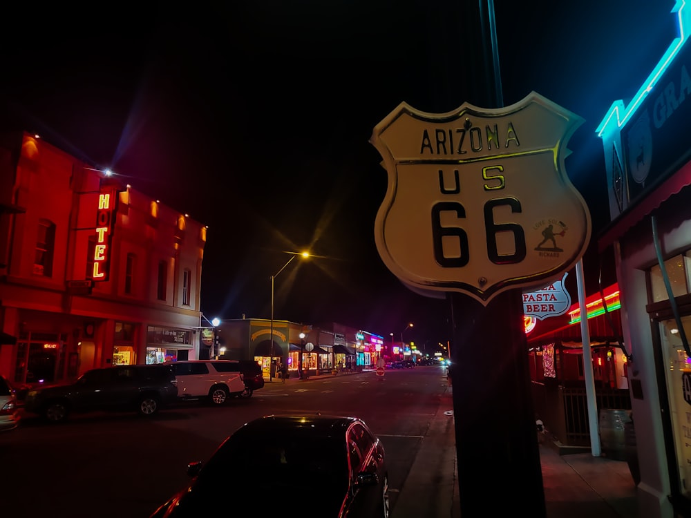 a street sign on the side of a road at night