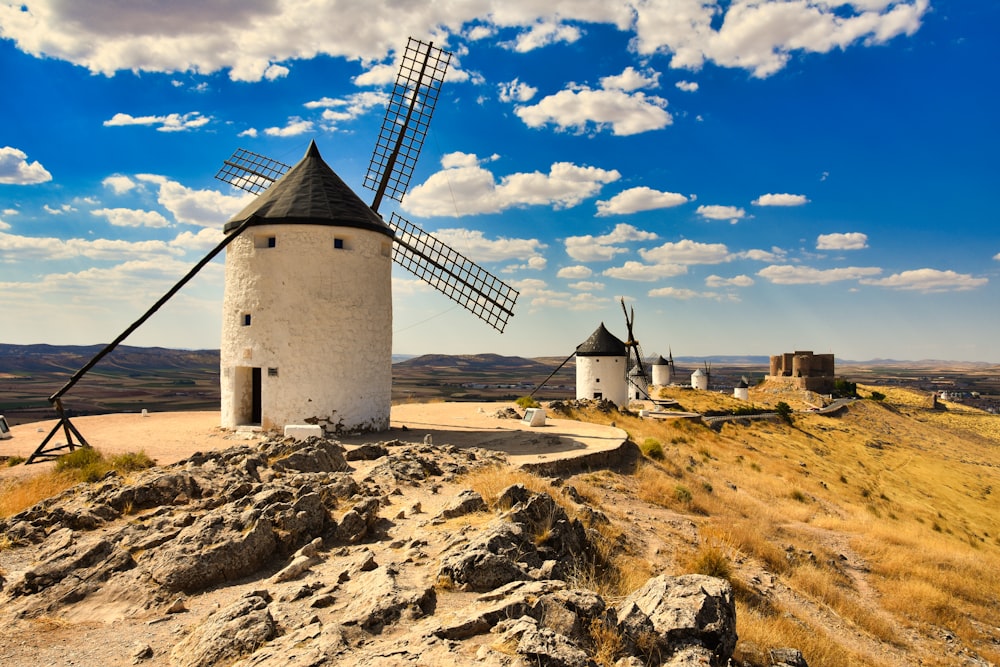 a windmill on top of a rocky hill
