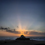 Sunset behind a newly completed campground chapel with assembled community members.