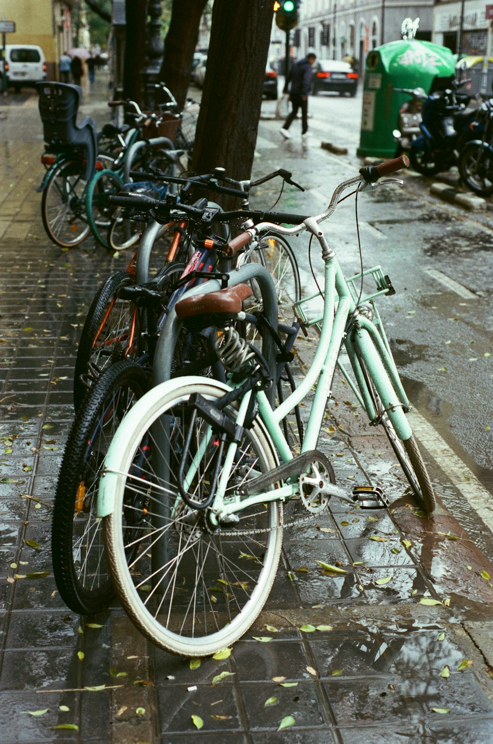 a row of parked bicycles sitting on the side of a street