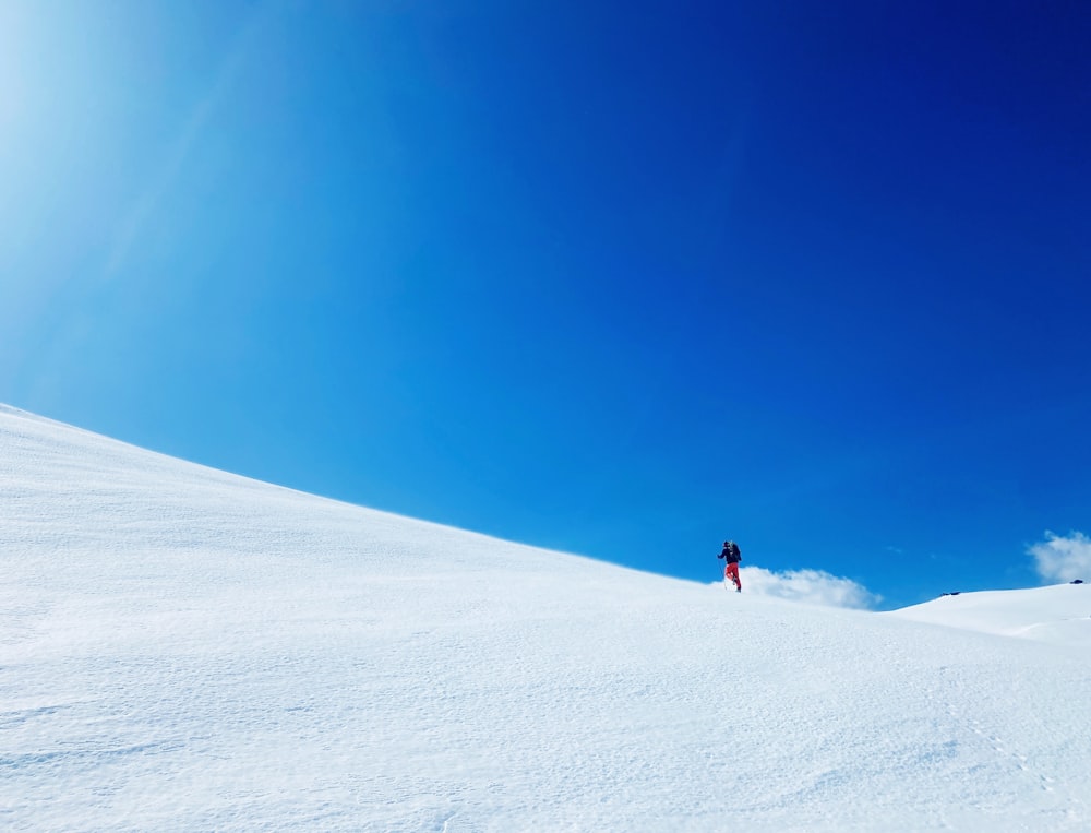 a person is skiing down a snowy hill