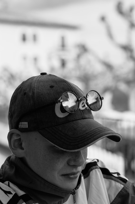 A street-style photo of a young person wearing a sisyph lab cap in an urban Moroccan setting.