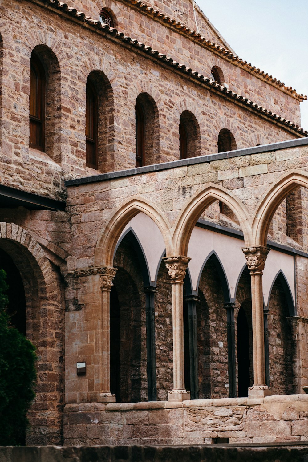 a stone building with arched windows and a clock