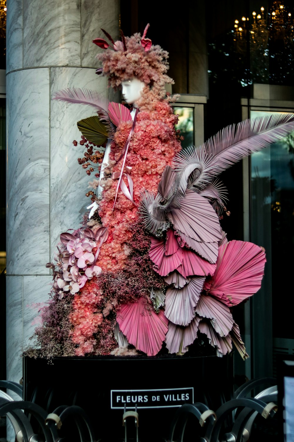 a display of flowers and feathers in a building