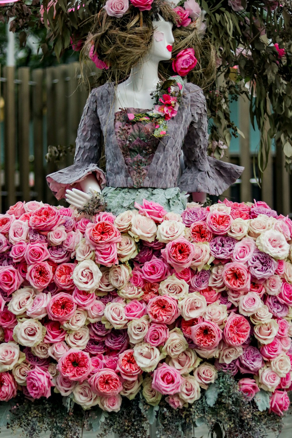 a mannequin dressed in a dress made out of flowers