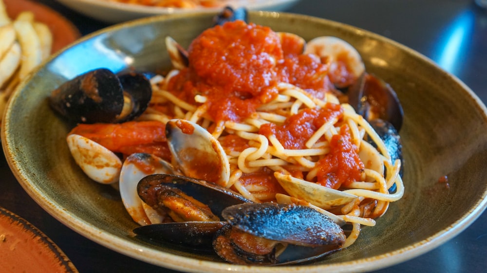 a plate of spaghetti with clams and mussels