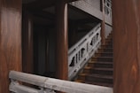 Detail of a staircase with polished wooden steps and handrails.