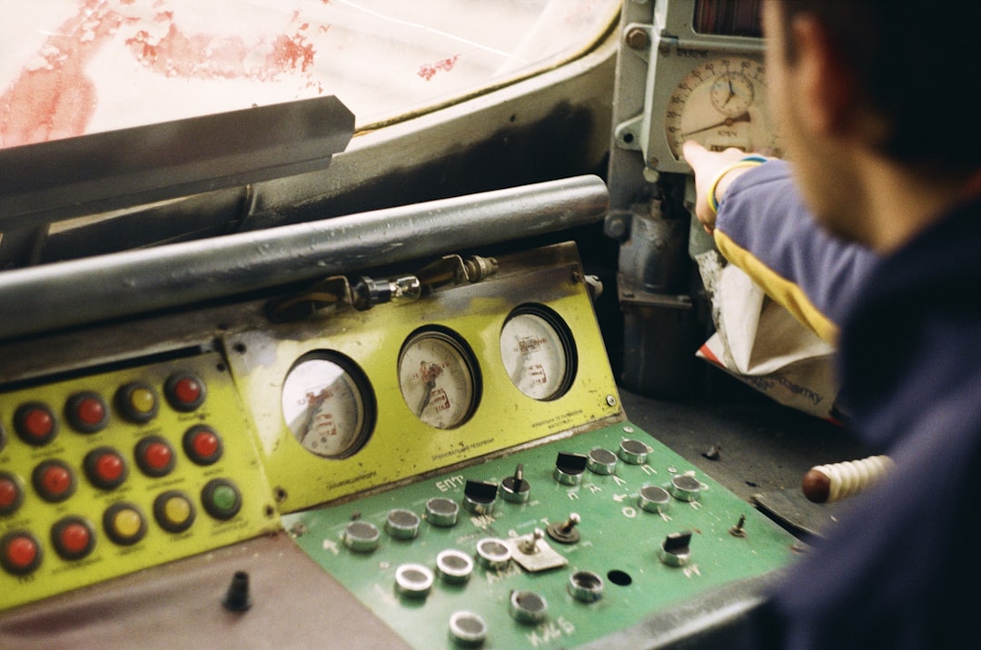 a man working on a machine in a factory, A guy in the driver