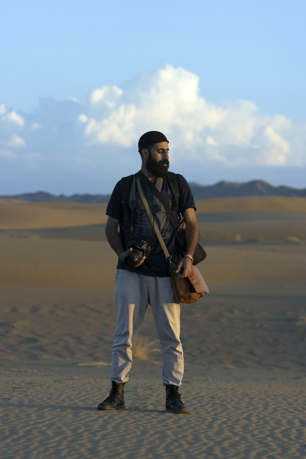 a man standing in the middle of a desert