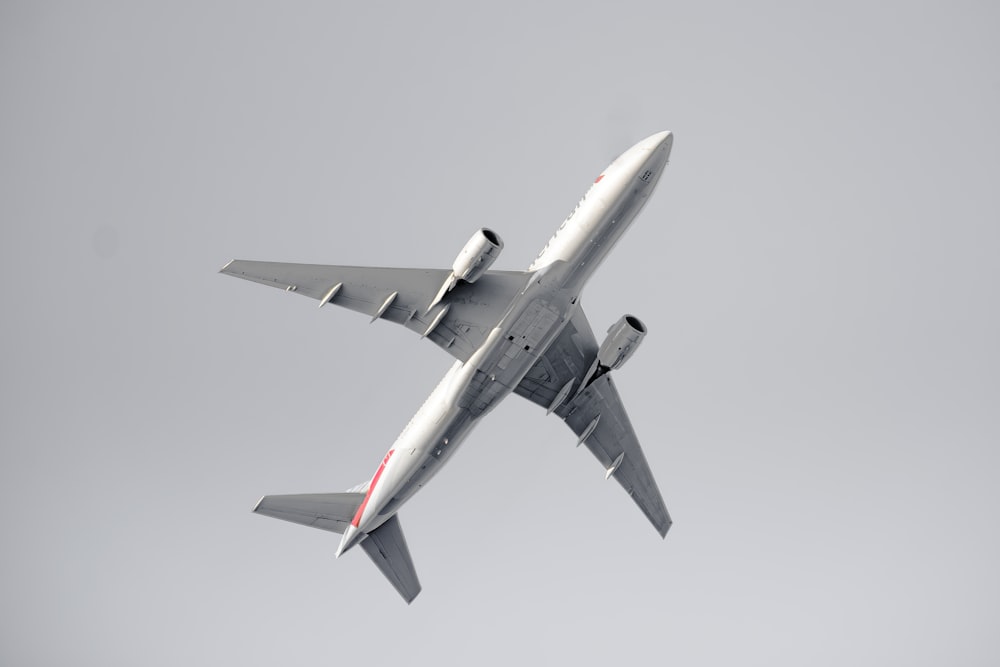 a large jetliner flying through a gray sky