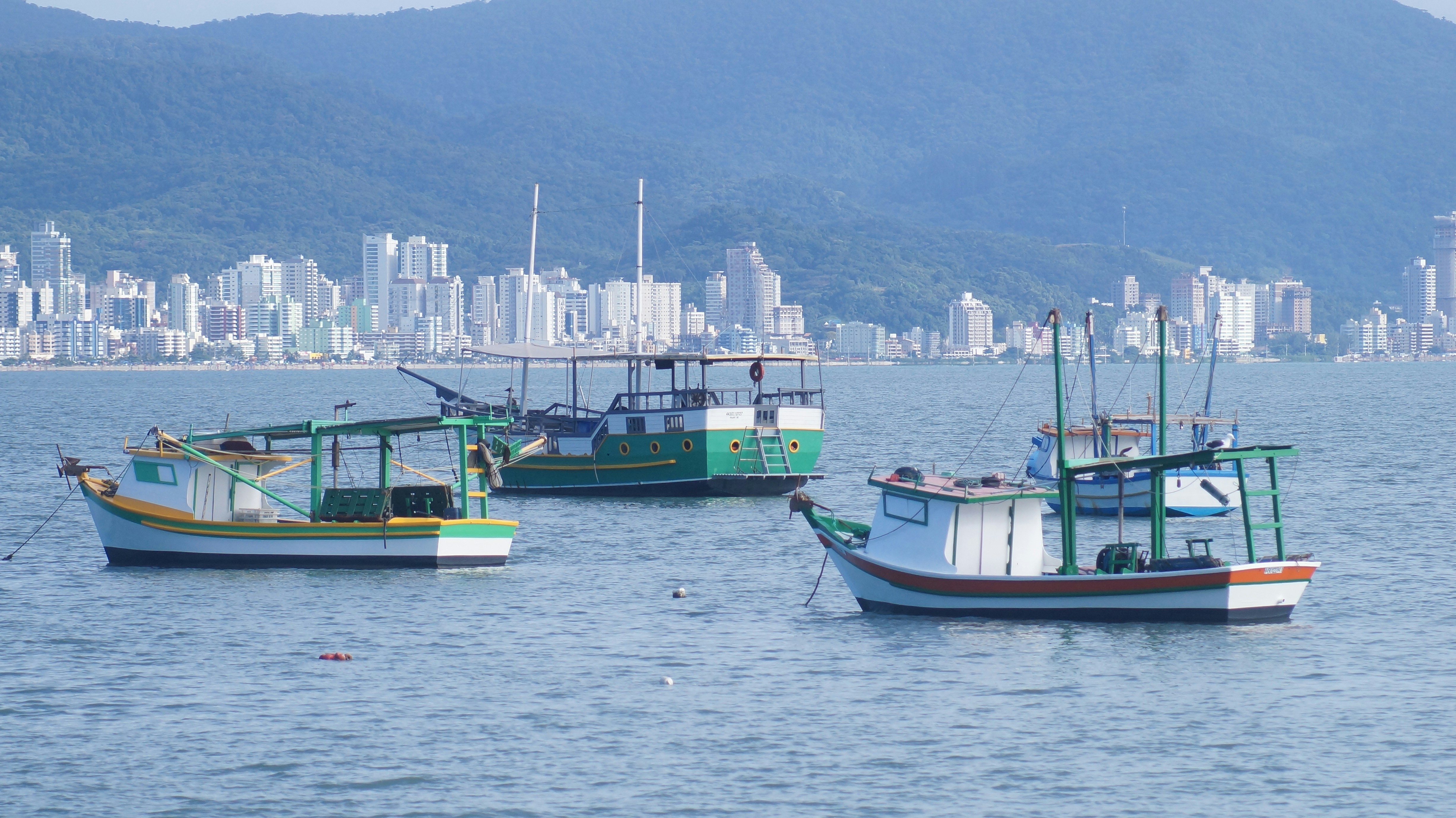 a group of boats floating on top of a large body of water