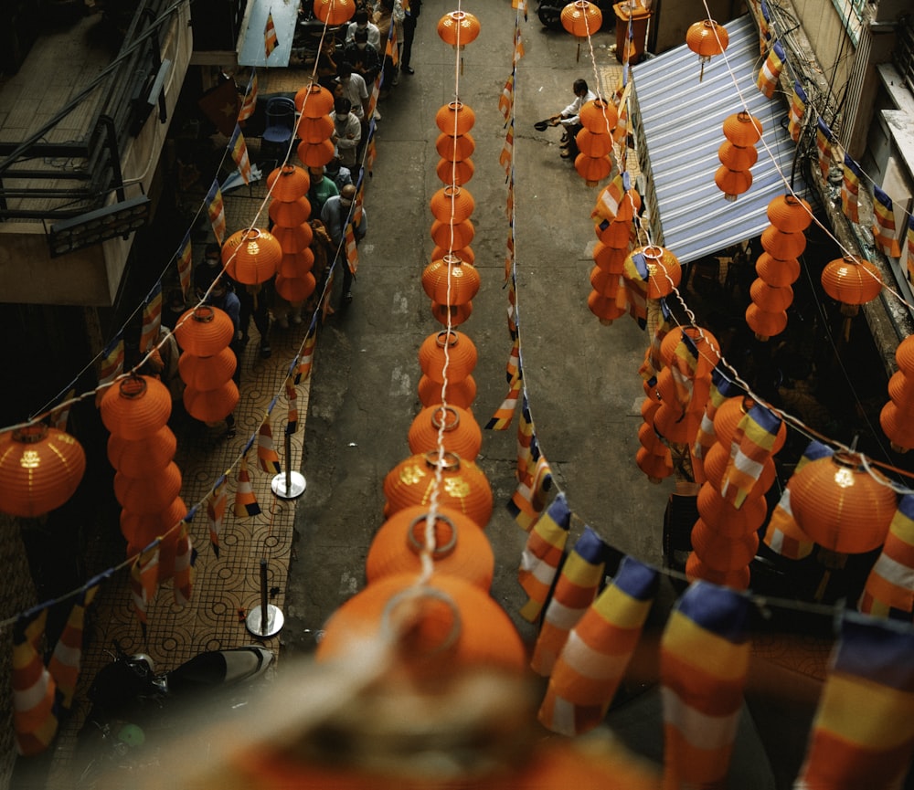 an overhead view of a street with orange lanterns